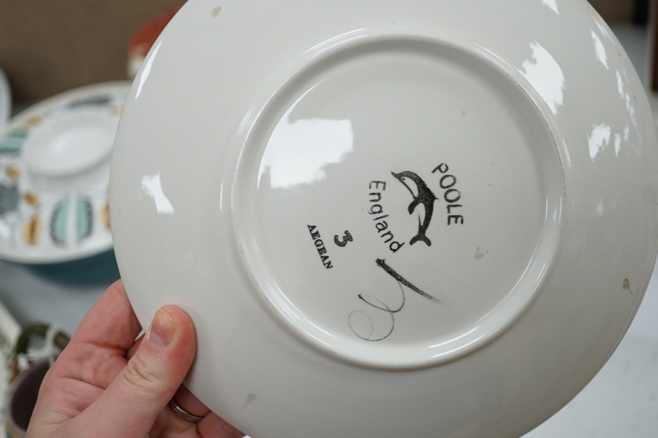 A collection of Poole pottery teapots, plates etc.